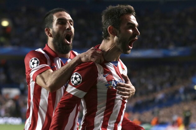 Atletico's Adrian Lopez, right, celebrates after scoring his sides first goal during the Champions League semifinal second leg soccer match between Chelsea and Atletico Madrid at Stamford Bridge stadium in London, Wednesday, April 30, 2014. (AP Photo/Matt Dunham)