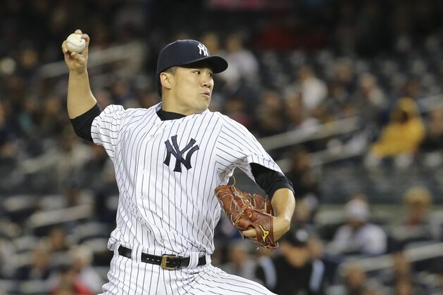 New York Yankees starting pitcher Masahiro Tanaka throws in the first inning of their baseball game against the Los Angeles Angels at Yankee Stadium, Sunday, April 27, 2014, in New York. The Yankees won 3-2. (AP Photo/John Minchillo)