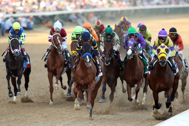 LOUISVILLE, KY - MAY 03:  Jockey Victor Espinoza guides California Chrome #5 to the finish line to win the 140th running of the Kentucky Derby at Churchill Downs on May 3, 2014 in Louisville, Kentucky.  (Photo by Matthew Stockman/Getty Images)