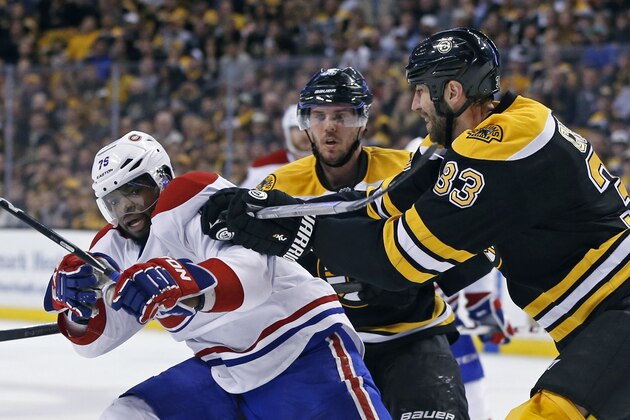 Boston Bruins defenseman Zdeno Chara (33) tries to move Montreal Canadiens defenseman P.K. Subban (76) off the puck as Bruins center David Krejci, middle, looks on during the second period in Game 2 of an NHL hockey second-round playoff series in Boston, Saturday, May 3, 2014. (AP Photo/Elise Amendola)
