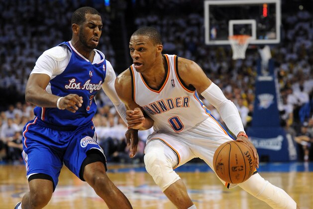 May 13, 2014; Oklahoma City, OK, USA; Oklahoma City Thunder guard Russell Westbrook (0) drives to the basket against Los Angeles Clippers guard Chris Paul (3) during the fourth quarter in game five of the second round of the 2014 NBA Playoffs at Chesapeake Energy Arena. Mandatory Credit: Mark D. Smith-USA TODAY Sports