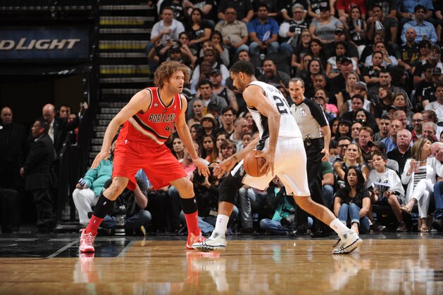 SAN ANTONIO, TX - MAY 14: Robin Lopez #42 of the Portland Trail Blazers defends against Tim Duncan #21 of the San Antonio Spurs in Game Five of the Western Conference Semifinals during the 2014 NBA Playoffs on May 14, 2014 at the AT&T Center in San Antonio, Texas. NOTE TO USER: User expressly acknowledges and agrees that, by downloading and/or using this Photograph, user is consenting to the terms and conditions of the Getty Images License Agreement. Mandatory Copyright Notice: Copyright 2013 NBAE (Photo by Garrett W. Ellwood/NBAE via Getty Images)