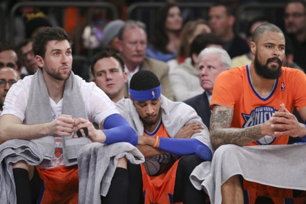 New York Knicks shooting guard Toure' Murry (23), center bows his head alongside power forward Andrea Bargnani (77), left, and center Tyson Chandler (6), right, during the second half of their NBA basketball game against the Oklahoma City Thunder at Madison Square Garden, Wednesday, Dec. 25, 2013, in New York. The Thunder defeated the Knicks 123-94. (AP Photo/John Minchillo)