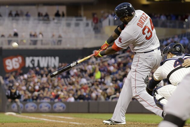 Boston Red Sox designated hitter David Ortiz hits a solo home run off Minnesota Twins relief pitcher Caleb Thielbar during the fifth inning of a baseball game in Minneapolis, Wednesday, May 14, 2014.  (AP Photo/Ann Heisenfelt)