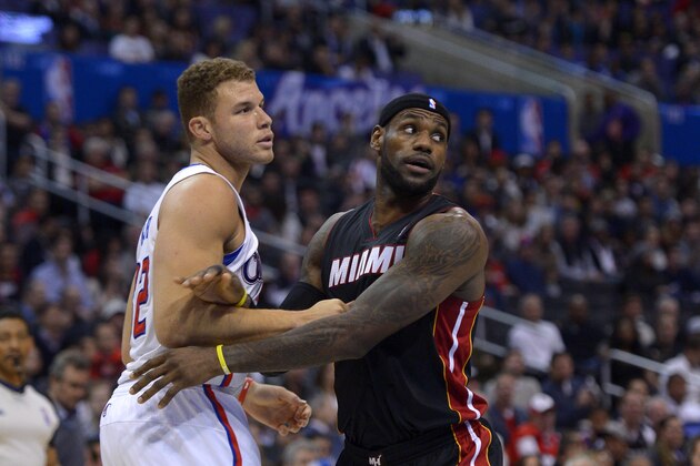 Los Angeles Clippers forward Blake Griffin, left, and Miami Heat forward LeBron James vie for a rebound during the first half of an NBA basketball game, Wednesday, Feb. 5, 2014, in Los Angeles. (AP Photo/Mark J. Terrill)
