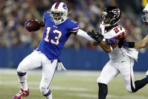 FILE - In this Dec. 1, 2013, file photo, Buffalo Bills wide receiver Stevie Johnson (13) pushes off Atlanta Falcons cornerback Robert McClain (27) during the first half of an NFL football game in Toronto.  The Bills traded Johnson to the San Francisco 49ers on Friday, May 9, 2014, in a deal made before the start of the second round of the NFL draft.  (AP Photo/Gary Wiepert, File)