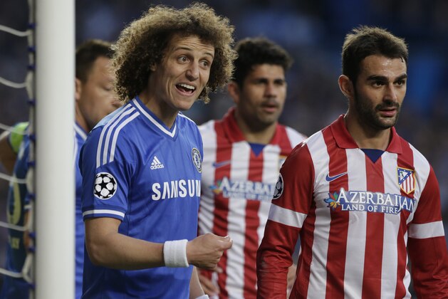 Chelsea's David Luiz, left, gestures to his teammates as he waits by the oat for a corner kick to be taken during the Champions League semifinal second leg soccer match between Chelsea and Atletico Madrid at Stamford Bridge stadium in London, Wednesday, April 30, 2014. (AP Photo/Matt Dunham)