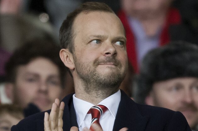 Manchester United chief executive Ed Woodward applauds before the team's English Premier League soccer match against Tottenham at Old Trafford Stadium, Manchester, England, Wednesday Jan. 1, 2014. (AP Photo/Jon Super)