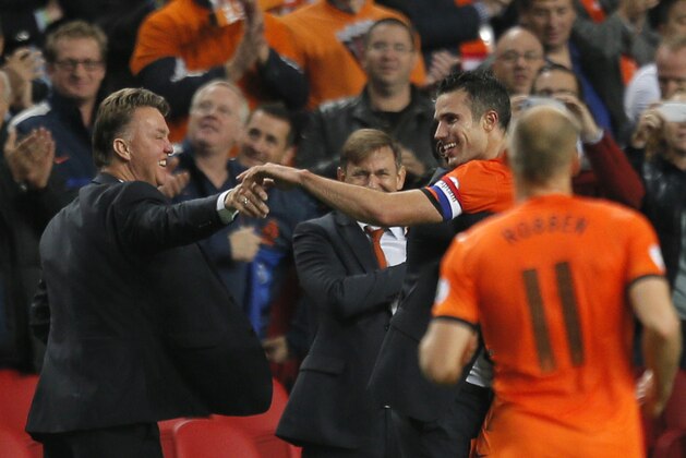 Netherlands' Robin van Persie, right, and Netherlands' manager Louis van Gaal, left, celebrate after Netherlands scored their forth goal during the Group D World Cup qualifying soccer match between Netherlands and Hungary, at ArenA stadium in Amsterdam, Netherlands, Friday Oct. 11, 2013. (AP Photo/Peter Dejong)