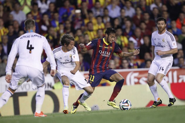 Barcelona's Neymar, 3rd left tries to get past Real's Sergio Ramos, left, Fabio Coentrao, centre and  Xabi Alonso during the final of the Copa del Rey between FC Barcelona and Real Madrid at the Mestalla stadium in Valencia, Spain, Wednesday, April 16, 2014. (AP Photo/Alberto Saiz)
