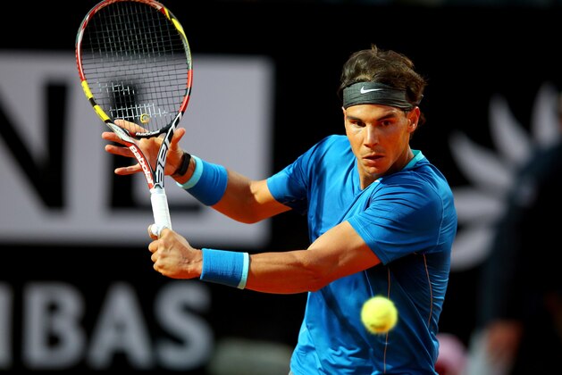ROME, ITALY - MAY 14:  Rafael Nadal of Spain in action against Gilles Simon of France during day four of the Internazionali BNL d'Italia tennis 2014 on May 14, 2014 in Rome, Italy.  (Photo by Julian Finney/Getty Images)