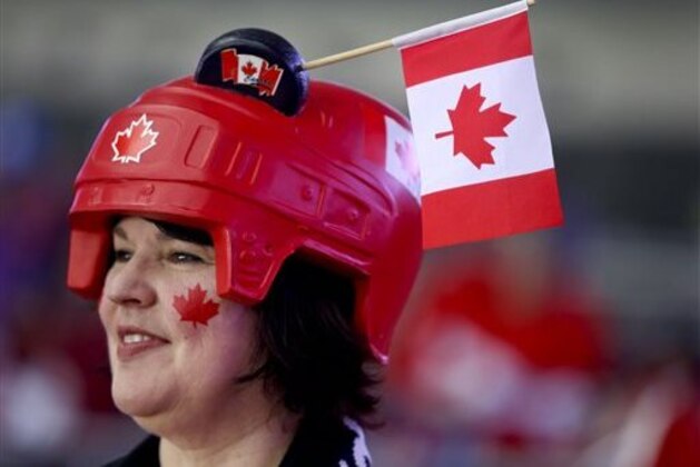 Doris Lipscombe watches team Canada warm up before playing Sweden in the gold medal men's ice hockey game at the 2014 Winter Olympics, Sunday, Feb. 23, in Sochi, Russia. (AP Photo/Mark Humphrey)