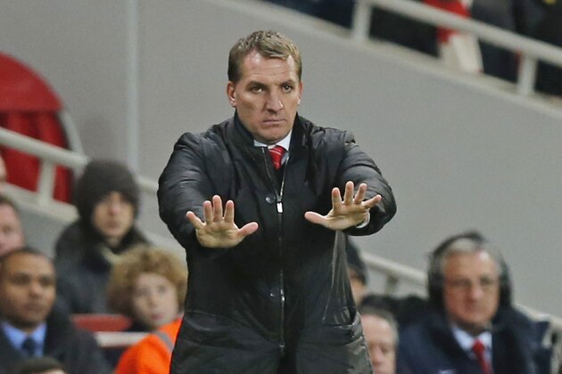 Liverpool's manager Brendan Rodgers gestures to his players as he watches his team play against Arsenal during their English FA Cup fifth round soccer match at Emirates Stadium in London, Sunday, Feb. 16, 2014. (AP Photo/Sang Tan)