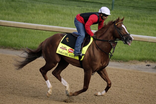 An exercise rider takes Kentucky Derby hopeful Pablo Del Monte for a morning workout at Churchill Downs Thursday, May 1, 2014, in Louisville, Ky. (AP Photo/Charlie Riedel)