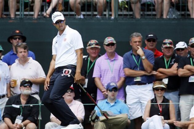 Adam Scott, of Australia, reacts to missing a putt on the first green during the fourth round of the Masters golf tournament Sunday, April 13, 2014, in Augusta, Ga. (AP Photo/David J. Phillip)