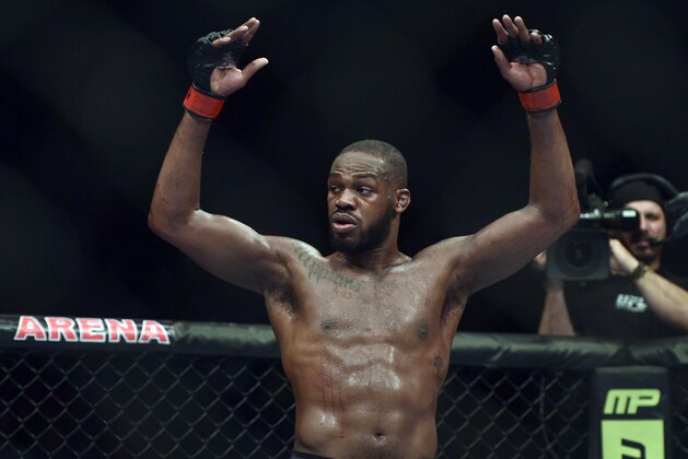Apr 26, 2014; Baltimore, MD, USA;  Jon Jones puts his arms in the air after the UFC light heavy weight championship fight against Glover Texeira at  Baltimore Arena. Jones retained the light heavy height championship by defeating  Teixeria.  Mandatory Credit: Tommy Gilligan-USA TODAY Sports