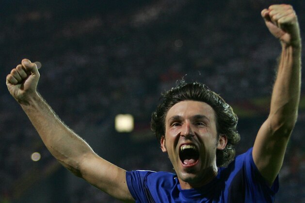 Italy's Andrea Pirlo celebrates his side's first goal by teammate Fabio Grosso in the extra time of the semifinal World Cup soccer match between Germany and Italy in Dortmund, Germany, Tuesday, July 4, 2006. Italy won the match 2-0 in extra time.   (AP Photo/Andrew Medichini)  ** MOBILE/PDA USAGE OUT **