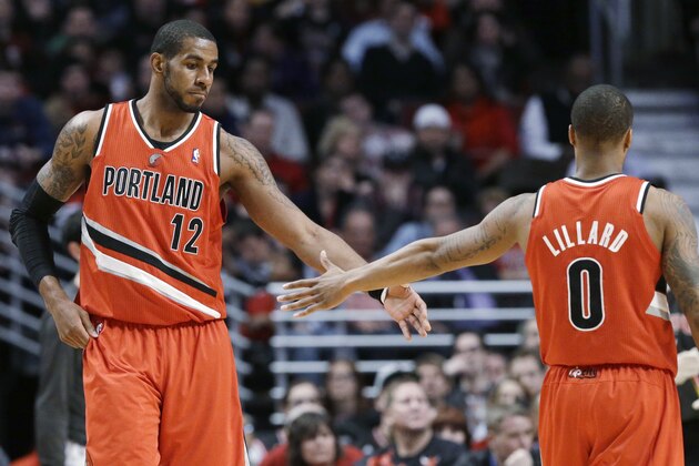 Portland Trail Blazers forward LaMarcus Aldridge, left, celebrates with guard Damian Lillard after scoring a basket during the second half of an NBA basketball game against the Chicago Bulls in Chicago on Thursday, March 21, 2013. The Trail Blazers won 99-89. (AP Photo/Nam Y. Huh)