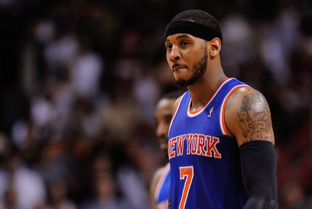 Apr 6, 2014; Miami, FL, USA; New York Knicks forward Carmelo Anthony (7) walks back to the bench during the second half against the Miami Heat at American Airlines Arena. Miami won 102-91. Mandatory Credit: Steve Mitchell-USA TODAY Sports