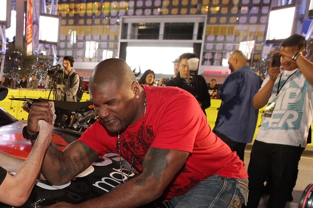 LOS ANGELES, CA - JANUARY 21:  Travis Pastrana (L) and Quinton 'Rampage' Jackson arm wrestle at the Pastrana-Waltrip Racing announcement of the 2011 NASCAR Nationwide partnership on January 21, 2011 in Los Angeles, California.  (Photo by Noel Vasquez/Getty Images for Waltrip Racing)