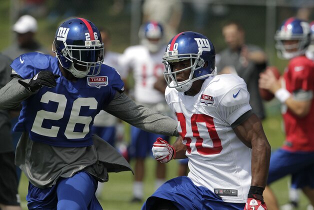 July 30, 2012; Albany, NY, USA; New York Giants Antrel Rolle (26) covers Victor Cruz (80) during New York Giants training camp. Mandatory Credit: Tim Farrell/THE STAR-LEDGER via USA TODAY Sports