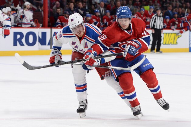 MONTREAL, QC - APRIL 12: Daniel Briere #48 of the Montreal Canadiens fights for the puck against Marc Staal #18 of the New York Rangers during the NHL game on April 12, 2014 at the Bell Centre in Montreal, Quebec, Canada. (Photo by Francois Lacasse/NHLI via Getty Images)