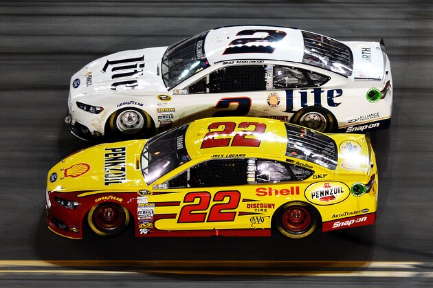 DAYTONA BEACH, FL - FEBRUARY 23:  Joey Logano, driver of the #22 Shell-Pennzoil Ford, races Brad Keselowski, driver of the #2 Miller Lite Ford, during the NASCAR Sprint Cup Series Daytona 500 at Daytona International Speedway on February 23, 2014 in Daytona Beach, Florida.  (Photo by Jared C. Tilton/Getty Images)