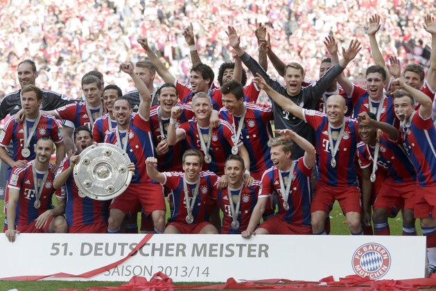 Munich's players celebrate with the trophy for winning the German Soccer Championships after the season's last match between FC Bayern Munich and VfB Stuttgart, in Munich, southern Germany, Saturday, May 10, 2014. (AP Photo/Matthias Schrader)