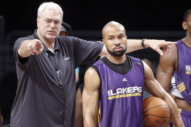 Los Angeles Lakers coach Phil Jackson directs Derek Fisher, center, and others during basketball practice at Staples Center in Los Angeles, Wednesday, June 16, 2010,  as they prepare to meet the Boston Celtics in Game 7 of the NBA basketball finals.  (AP Photo/Reed Saxon)