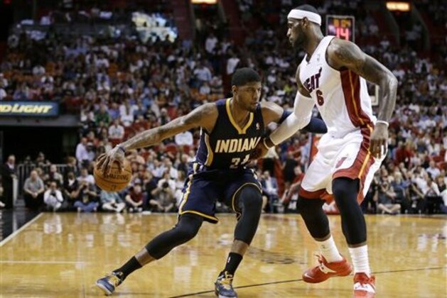 Indiana Pacers' Paul George (24) drives to the basket as Miami Heat's LeBron James (6) defends during the first half of an NBA basketball game, Friday, April 11, 2014, in Miami. (AP Photo/Lynne Sladky)