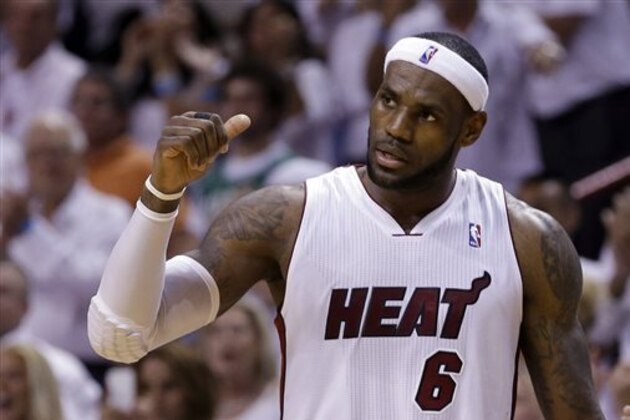 Miami Heat forward LeBron James (6) gives a thumbs-up to his teammates during the final minutes of the second half of Game 5 of a second-round NBA playoff basketball game against the Brooklyn Nets in Miami, Wednesday, May 14, 2014. The Heat won 96-94.  (AP Photo)