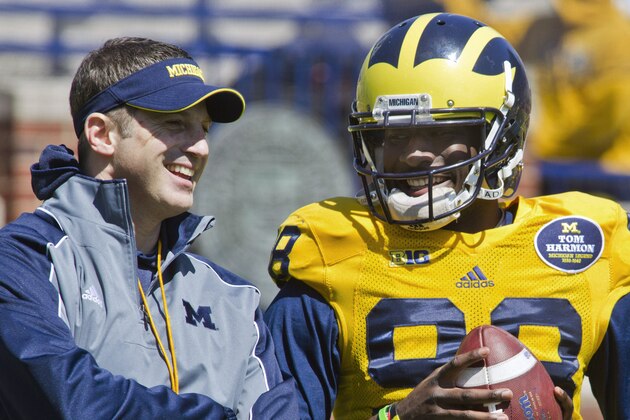 Michigan offensive coordinator Doug Nussmeier, left, laughs with quarterback Devin Gardner (98) during the NCAA college football team's annual spring game on Saturday, April 5, 2014, in Ann Arbor, Mich. (AP Photo/Tony Ding)