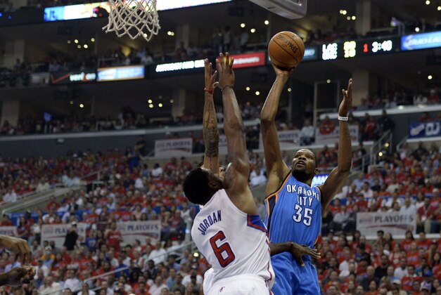 May 15, 2014; Los Angeles, CA, USA; Oklahoma City Thunder forward Kevin Durant (35) shoots against Los Angeles Clippers center DeAndre Jordan (6) during the first quarter in game six of the second round of the 2014 NBA Playoffs at Staples Center. Mandatory Credit: Richard Mackson-USA TODAY Sports