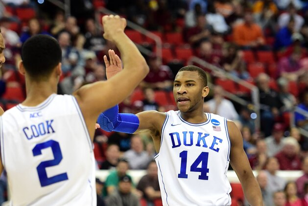Mar 21, 2014; Raleigh, NC, USA; Duke Blue Devils guard Rasheed Sulaimon (14) celebrates with Duke Blue Devils guard Quinn Cook (2) against the Mercer Bears in the second half of a men's college basketball game during the second round of the 2014 NCAA Tournament at PNC Arena. Mandatory Credit: Bob Donnan-USA TODAY Sports