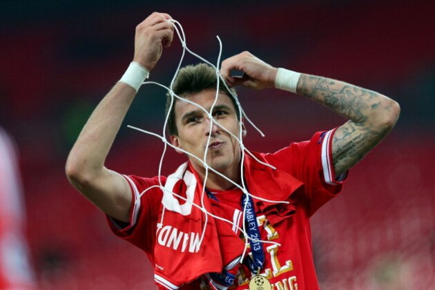 LONDON, ENGLAND - MAY 25:  Mario Mandzukic of Bayern Muenchen celebrates with a piece of goal netting after winning the UEFA Champions League final match against Borussia Dortmund at Wembley Stadium on May 25, 2013 in London, United Kingdom.  (Photo by Alex Livesey/Getty Images)