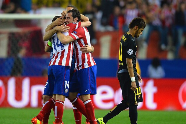 MADRID, SPAIN - APRIL 09: A dejected Neymar of Barcelona walks off the pitch as Gabi of Club Atletico de Madrid celebrates with team mates during the UEFA Champions League Quarter Final second leg match between Club Atletico de Madrid and FC Barcelona at Vicente Calderon Stadium on April 9, 2014 in Madrid, Spain.  (Photo by Laurence Griffiths/Getty Images)