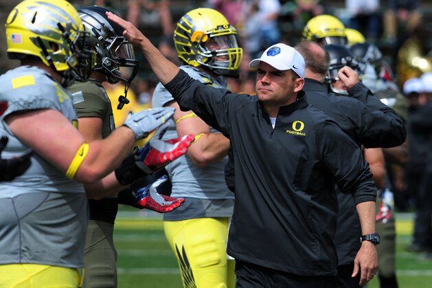 EUGENE, OR - MAY 3: Oregon Ducks head coach Mark Helfrich greets his players  before the Spring game at Autzen Stadium on May 3, 2014 in Eugene, Oregon. (Photo by Steve Dykes/Getty Images)