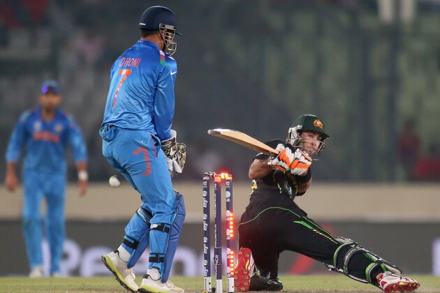 DHAKA, BANGLADESH - MARCH 30:  Glenn Maxwell of Australia is out bowled as MS Dhoni of India looks on during the ICC World Twenty20 Bangladesh 2014 match between India v Australia at Sher-e-Bangla Mirpur Stadium on March 30, 2014 in Dhaka, Bangladesh.  (Photo by Scott Barbour/Getty Images)