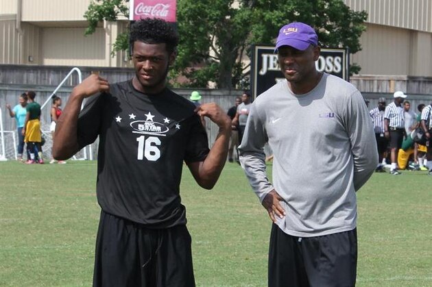 Cornerback prospect Xavier Lewis (left) stands next to LSU defensive backs coach Corey Raymond (right).