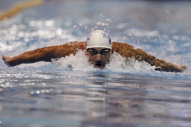 Michael Phelps swims the 100-meter butterfly in a preliminary round at the Arena Grand Prix swim meet in Charlotte, N.C., Friday, May 16, 2014. (AP Photo/Nell Redmond)