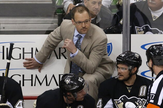 Pittsburgh Penguins head coach Dan Bylsma talks with referee Eric Furlatt (27) in the third period of game 2 of a second-round NHL playoff hockey series against the New York Rangers in Pittsburgh Sunday, May 4, 2014. The Penguins won 3-0, to even the series at 1-1. (AP Photo/Gene J. Puskar)