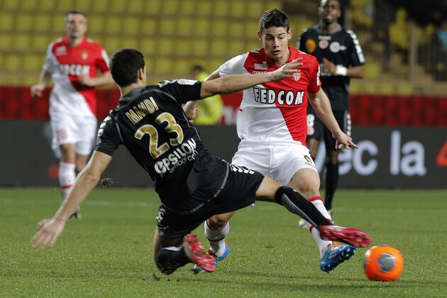 Monaco's James Rodriguez, right, challenges for the ball with Reims' player Aissa Mandi their French League One soccer match, in Monaco stadium, Friday, Feb. 21 , 2014. (AP Photo/Lionel Cironneau)