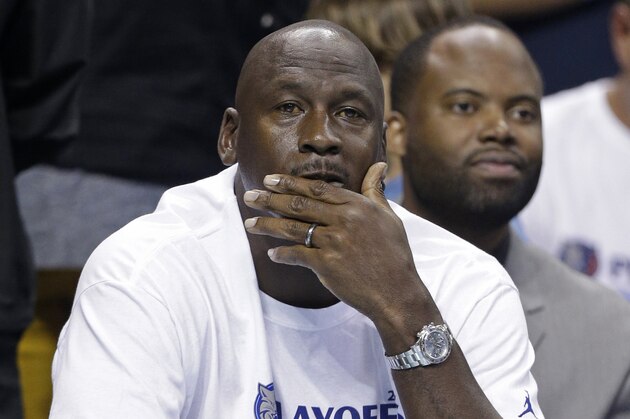 Charlotte Bobcats owner Michael Jordan watches the action during the first half in Game 4 of the Bobcats' opening-round NBA basketball playoff series against the Miami Heat in Charlotte, N.C., Monday, April 28, 2014. (AP Photo/Chuck Burton)