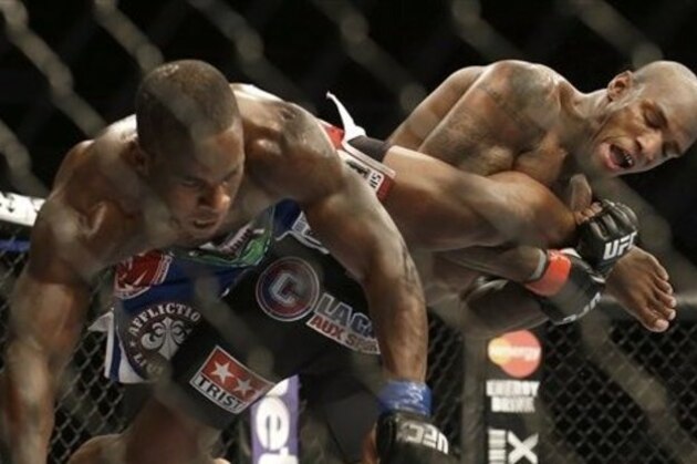 Francis Carmont, right, tries to take down Lorenz Larkin during the third round of a UFC middleweight mixed martial arts fight in San Jose, Calif., Saturday, April 20, 2013. Carmont won by unanimous decision. (AP Photo/Jeff Chiu)