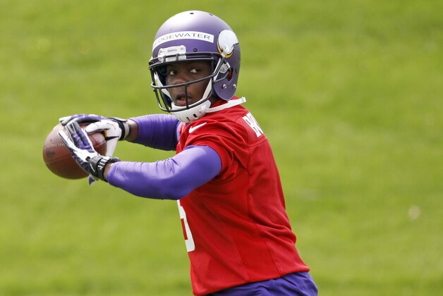 Quarterback Teddy Bridgewater drops back to pass during Minnesota Vikings minicamp in Eden Prairie, Minn., Friday, May 16, 2014. New Vikings coach Mike Zimmer set to work getting young players like Bridgewater, linebacker Anthony Barr and defensive backs Antone Exum and Kendall James up to speed on what will be expected of them in the NFL.  (AP Photo/Ann Heisenfelt)