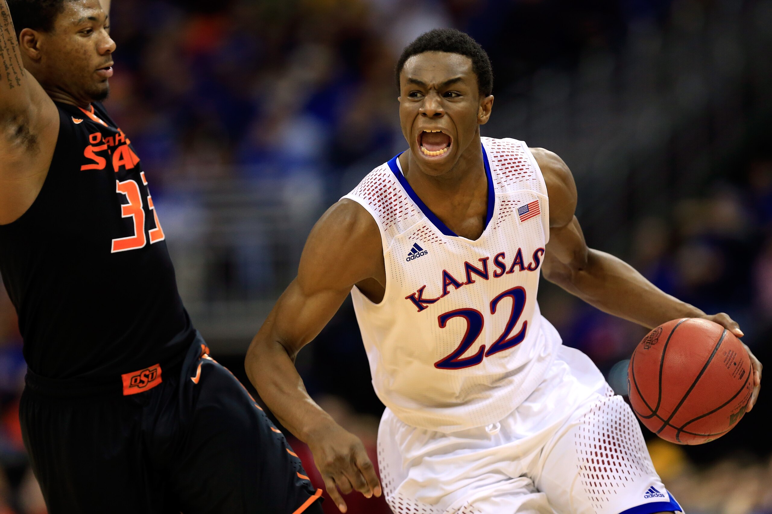 KANSAS CITY, MO - MARCH 13:  Andrew Wiggins #22 of the Kansas Jayhawks drives upcourt as Marcus Smart #33 of the Oklahoma State Cowboys defends during the Big 12 Basketball Tournament quarterfinal game at Sprint Center on March 13, 2014 in Kansas City, Missouri.  (Photo by Jamie Squire/Getty Images)