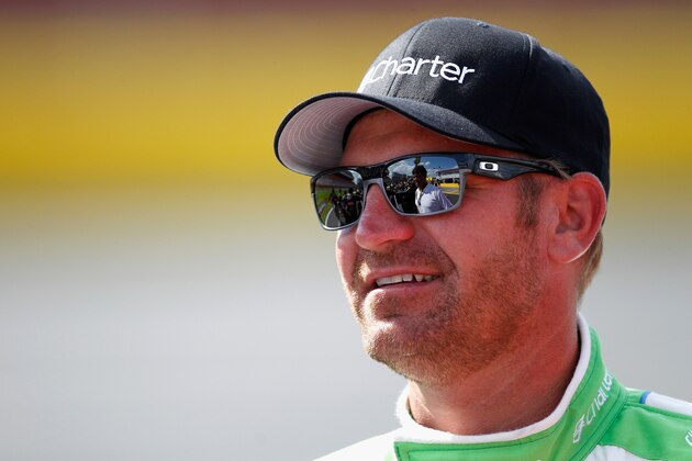 CHARLOTTE, NC - MAY 16:  Clint Bowyer, driver of the #15 Charter Toyota, talks to Michael Waltrip, of Michael Waltrip Racing, during qualifying for the NASCAR Sprint Cup Series Sprint Showdown at Charlotte Motor Speedway on May 16, 2014 in Charlotte, North Carolina.  (Photo by Sarah Glenn/Getty Images)