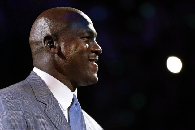 Charlotte Bobcats owner Michael Jordan speaks to fans before unveiling the new Charlotte Hornets logo during a ceremony at an NBA basketball game between the Charlotte Bobcats and the Utah Jazz in Charlotte, N.C., Saturday, Dec. 21, 2013. The Bobcats will change their name to Hornets starting next season. (AP Photo/Chuck Burton)