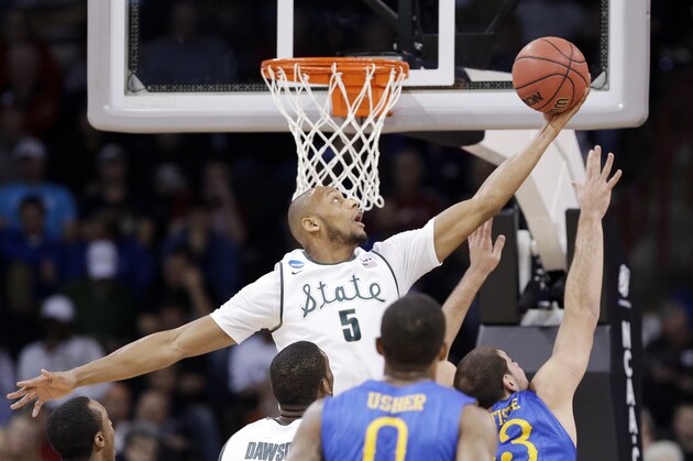 Adreian Payne (5) reaches for a loose ball against Delaware in the first half during the second round of the NCAA college basketball tournament in Spokane, Wash., Thursday, March 20, 2014. (AP Photo/Elaine Thompson)