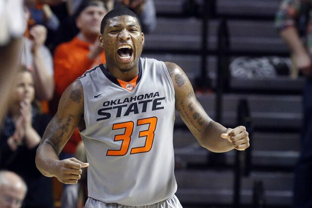 FILE - In this March 1, 2014, file photo, Oklahoma State guard Marcus Smart celebrates during the second half of an NCAA college basketball game against Kansas in Stillwater, Okla. Smart has declared for the NBA draft. He averaged 18 points, 5.9 rebounds and 4.8 assists per game this season. (AP Photo/Sue Ogrocki, File)